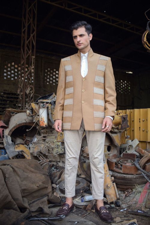 A vibrant crimson red velvet coat featuring a contemporary open-front cut and magnificent gold tilla and zardosi vine motifs sprawling across the shoulders.